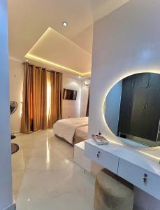 a bedroom with a bed and a large mirror at Luxury 3 bedroom Apartment in Lekki +16 photos