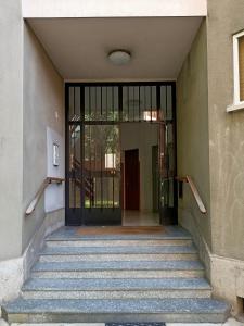 a staircase leading to a building with a glass door at Erika's Home in Milan