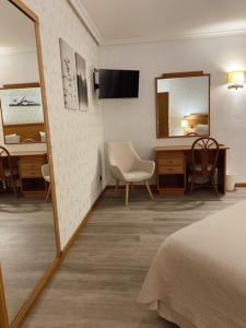 Uma cama ou camas num quarto em Hotel Lusitano