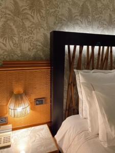 Uma cama ou camas num quarto em Hotel Lusitano