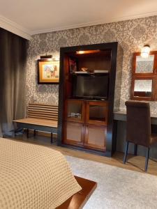 Uma cama ou camas num quarto em Hotel Lusitano