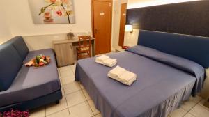 Postel nebo postele na pokoji v ubytování Hotel Villa Camilla