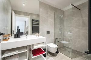 a bathroom with a sink and a toilet and a shower at Orange Luxury King bed Apartment, bussiness, leisure in One Cotroceni in Bucharest +43 photos