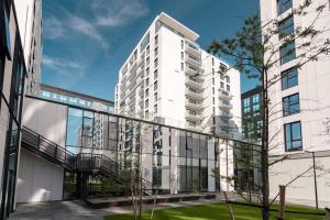 an exterior view of a white apartment building at Orange Luxury King bed Apartment, bussiness, leisure in One Cotroceni in Bucharest