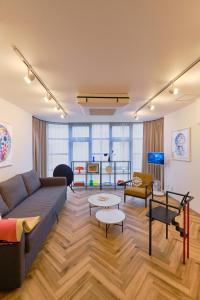 a living room with a couch and a table at Kaikai House - Art, Design & Family in Shibuya in Tokyo