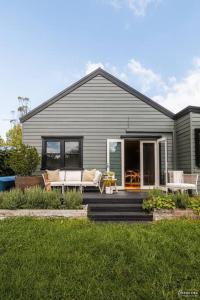 a gray house with a porch and a patio at The Waratah House close to town center in Katoomba