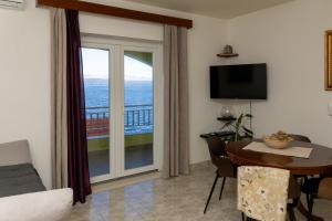 a living room with a table and a view of the ocean at Apartments by the sea Prigradica, Korcula - 544 in Blato