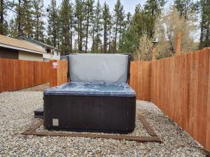 ein Koffer, der neben einem Zaun auf dem Boden steht in der Unterkunft NEW Cozy Coy Cabin with Hot Tub & AC in Big Bear City