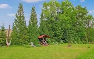 a gazebo in a field with chairs and trees at Wohnung Templin Ot Dargersdorf in Dargersdorf +7 photos