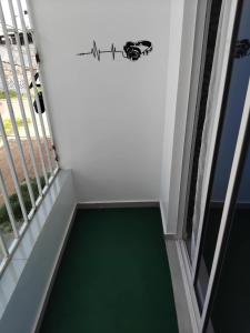 a stairway with a green floor next to a window at Apartamento em Pedra Badejo in Pedra Badejo