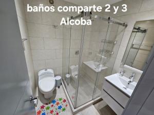 a bathroom with a shower and a toilet and a sink at Apartamento Turistico Torre del molino in Bogotá