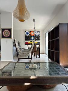 a living room with a glass table and chairs at Zen Home in Tulum