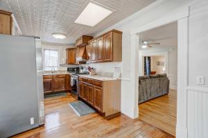 a kitchen with wooden cabinets and a couch at 1BR Quiet Neighborhood & Nearby Parks in Manitou Springs