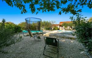 a yard with two chairs and a pool at One-Bedroom Holiday Home In Konjevrate in Konjevrate +29 photos