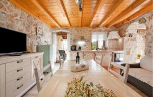 a kitchen with a tv and a living room at One-Bedroom Holiday Home In Konjevrate in Konjevrate