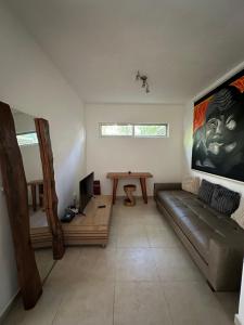 a living room with a couch and a table at Zen Home in Tulum