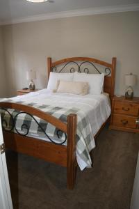 a bedroom with a large bed with a wooden frame at Snow Summit Getaway Home in Big Bear Lake