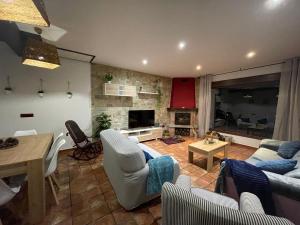 a living room with a couch and a table at Casa La Peguera in La Parra