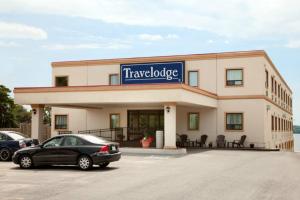 a car parked in a parking lot in front of a building at Travelodge by Wyndham Trenton in Trenton