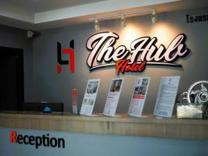 a sign for theitz hotel on a counter in a restaurant at The Hub Hotel Surin in Surin
