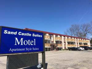 a blue sign in front of a building at Sand Castle Suites Motel in Port Elgin