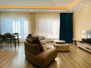 a living room with a couch and a television at In the central of Ulaanbaatar, Selbe Comfort Apartment, 9f 187 in Ulaanbaatar