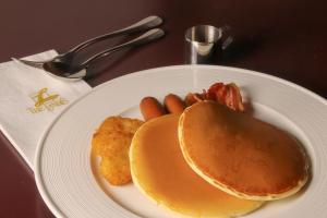 a white plate with breakfast food on a table at The Landis Taipei in Taipei