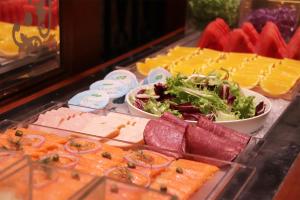 a buffet of food with cheese and meats and vegetables at The Landis Taipei in Taipei