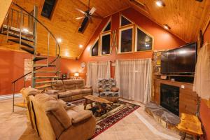a living room with a fireplace and a tv at Cozy Cabin By the Slopes in McHenry