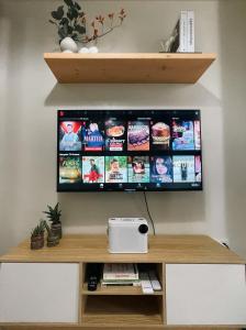 a flat screen tv hanging on a wall at 10mins to MOA Japan Aesthetic with Balcony Karaoke Kitchen 3mins to PICC in Manila