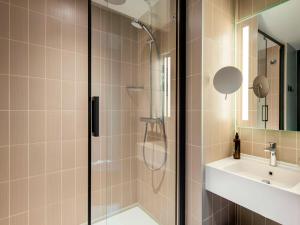 a bathroom with a shower and a sink at Aparthotel Adagio London City East in London
