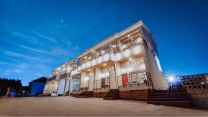 a building at night with lights on at Gangneung Olraeendaol Spa Pension in Gangneung +6 photos