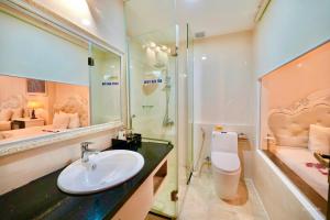 a bathroom with a sink and a shower and a toilet at Tuyet Son Hotel (TS Ocean Hotel) in Da Nang