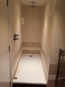 a shower stall in a bathroom with a floor at The Crown Wetherspoon in Worcester
