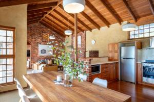 a kitchen with a wooden table and a dining room at Three Bears Cottage I Private Properties in Yallingup