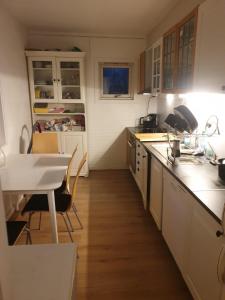 a kitchen with a sink and a table in it at Tevlingveien 9 in Alnabru