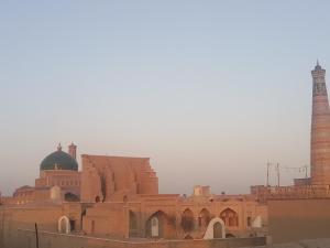 a large building with a mosque and a minaret at Fayz Guest House in Khiva