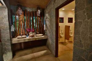 a bathroom with two sinks and a mirror at Casa Los Cocoteros in Gallinero +24 photos