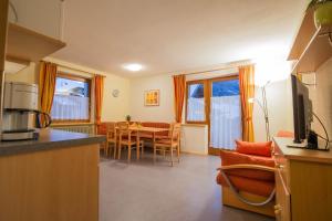 a kitchen and dining room with a table and chairs at Haus Waltraud in Neustift im Stubaital