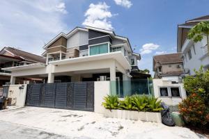 a large white house with a black gate at Retro Homestay Ipoh - Semi D 15pax Wedding in Ipoh