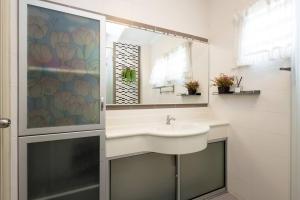 a bathroom with a sink and a mirror at Retro Homestay Ipoh - Semi D 15pax Wedding in Ipoh +44 photos