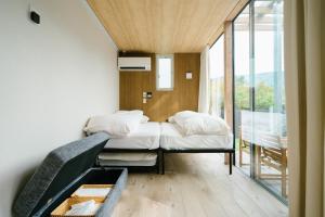 Postel nebo postele na pokoji v ubytování グランステイ湯布院 GranStay YUFUIN