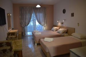 Postel nebo postele na pokoji v ubytování Xenios Zeus Hotel + 37 fotografií
