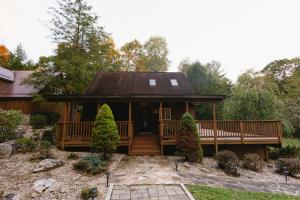 a home with a large deck and a house at Cozy Cabin By the Slopes in McHenry