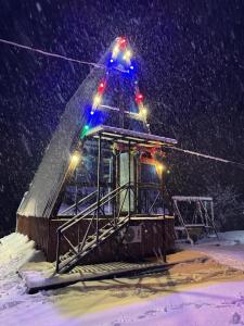 a ski lift with lights on it in the snow at Paradise Keda in Keda