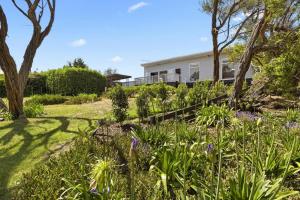 a garden in front of a house at Rye Beach Retreat - newly renovated with private garden and alfresco dining in Rye