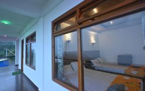 a room with a window with a bed in it at The Cherry Blossom Homestay By StayApart in Takdāh