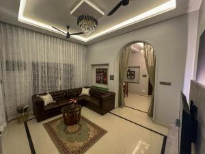 a living room with a couch and a table at 4bhk Luxury Villa in Mangalore