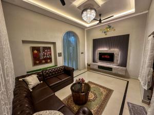 a living room with a couch and a tv at 4bhk Luxury Villa in Mangalore +31 photos