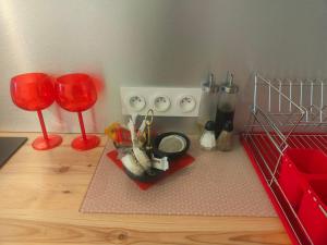 a kitchen with two red wine glasses and a stove at Le romantique in Argelès-sur-Mer +3 photos